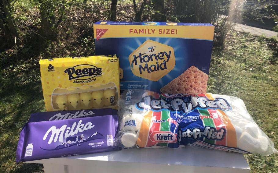 The ingredients are assembled for a snacking experiment during the coronavirus quarantine: s'mores with Milka bars and Peeps alongside the traditional marshmallows and graham crackers.