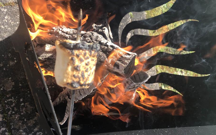 A marshmallow is overcooked over an open flame as part of a s'mores experiment. Conventional marshmallows turned out to be superior to Peeps in the snack.