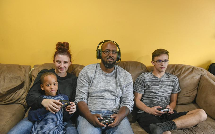 James Martin, center, a Marine veteran of Iraq and Afghanistan, plays video games Sept. 23, 2018, with his family in his home just outside of Pittsburgh, Pa. Martin, a volunteer for the Wounded Warrior Project, hopes to connect veterans during the coronavirus pandemic through online gaming.