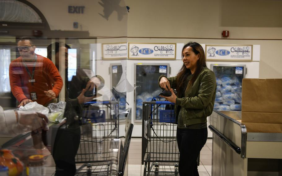 U.S. Air Force Senior Airman Sherraye Carter, 606th Airfield Control Squadron unit deployment manager, checks out at the commissary on Aviano Air Base, Italy, March 30, 2020, after picking up groceries for someone who's confined to their home under Italy's sweeping coronavirus restrictions.