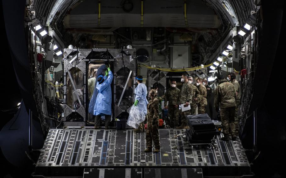 Airmen prepare to offload coronavirus patients at Ramstein Air Base, Germany, April 10, 2020, during the first-ever operational use of the Transport Isolation System. The TIS is an infectious disease containment unit designed to minimize contamination risk to aircrew and medical attendants, while allowing in-flight medical care for patients with an infectious disease.