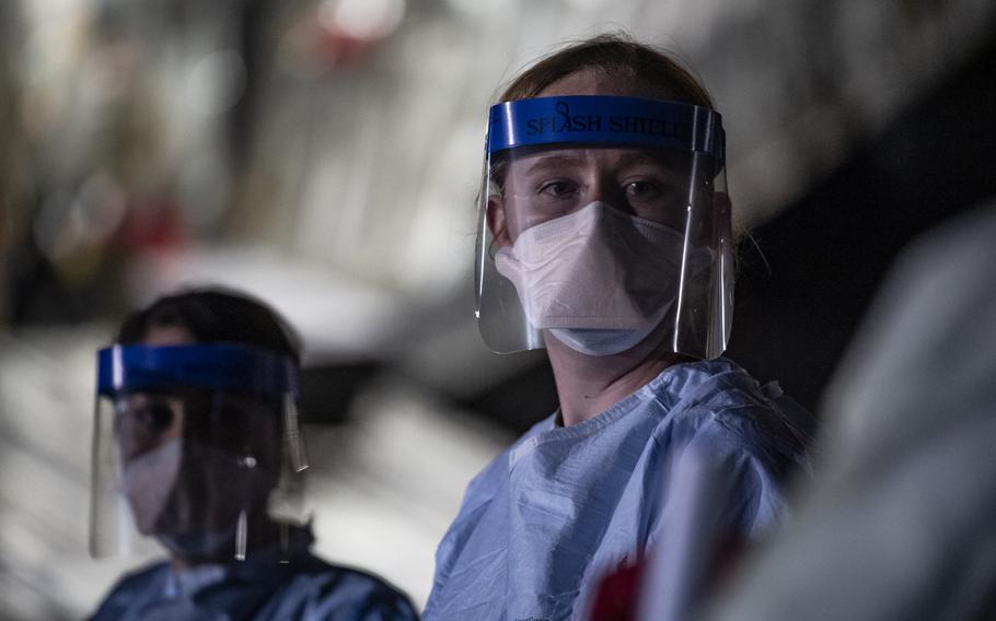 A  medical airman awaits transport documentation at Ramstein Air Base, Germany, April 10, 2020 following the first-ever operational use of the Transport Isolation System. Three patients with coronavirus were evacuated from Afghanistan to Ramstein in the TIS, which was designed in 2014 to transport Ebola patients.