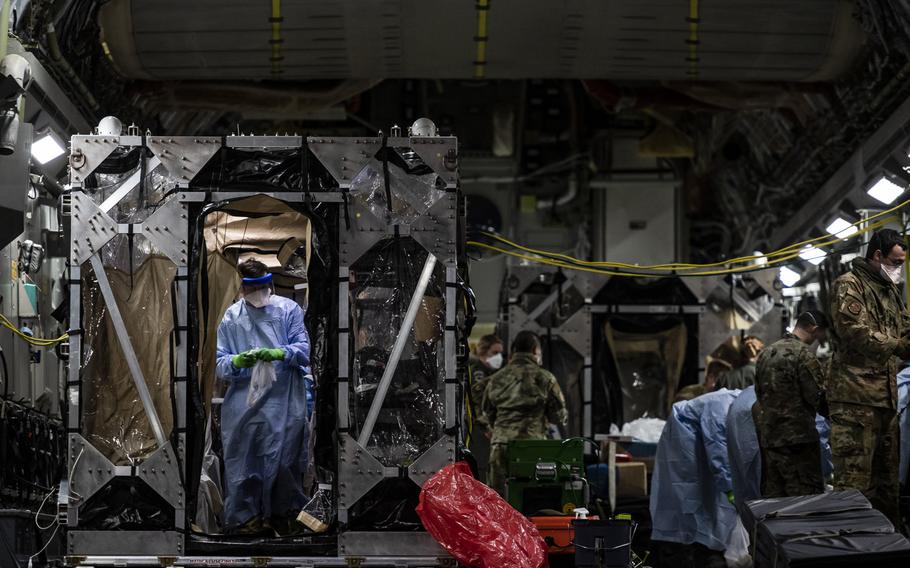 U.S. Air Force airmen aboard a C-17 Globemaster III aircraft begin disinfecting and decontaminating the aircraft after the first-ever operational use of the Transport Isolation System at Ramstein Air Base, Germany, April 10, 2020. The TIS is an infectious disease containment unit designed to evacuate patients with an infectious disease, in this case COVID-19.