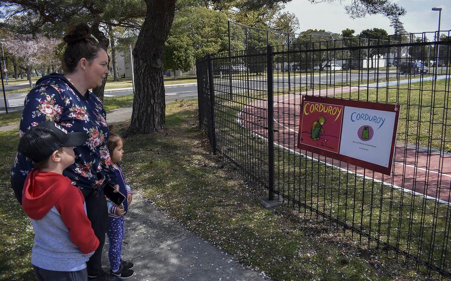 Danielle Carmona and her children, Camden, 6, and Kaia, 4, follow a story walk early this month at Sagamihara Housing Area near Camp Zama, Japan.