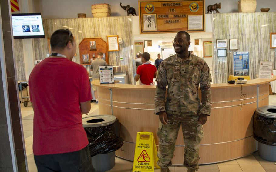 Army Sgt. Dwight Allen stands watch to ensure social distancing and galley regulations are adhered to in the Dorie Miller Galley at Camp Lemonnier, Djibouti, April 5, 2020.