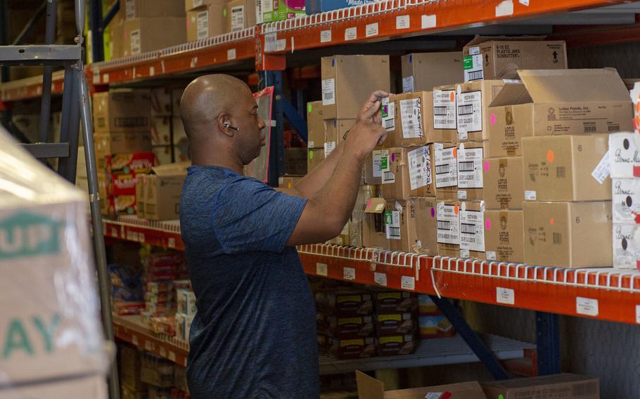Maryland National Guardsman Sgt. Maj. Alonzo Amison  volunteers to assist the Navy Exchange in restocking items in the warehouse, April 5, 2020, at Camp Lemonnier, Djibouti.