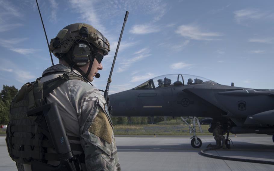 A U.S. Air Force Special Tactics Operator monitors communications while logistics readiness airmen fuel an F-15E Strike Eagle during an exercise at Amari Air Base, Estonia, in July 2019. The U.S. was the top military spender by a wide margin in 2019, accounting for 38% of global military expenditures, a report released Sunday, April 26, 2020 by the Stockholm International Peace Research Institute shows.