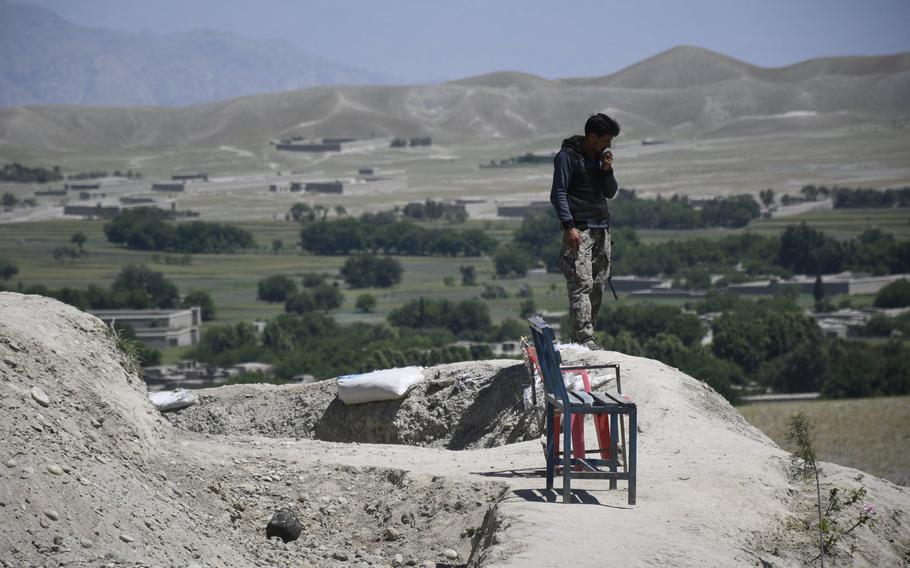 A soldier with the Afghan National Army's Territorial Force looks out across rural Nangarhar province on May 10, 2020. Two days later, President Ashraf Ghani ordered troops to resume offensive operations against the Taliban amid a surge in deadly violence in the country.