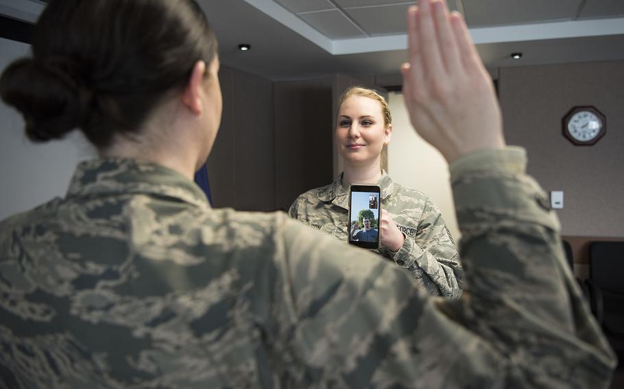 Staff Sgt. Elysia Wilson, 168th Wing production recruiter, helps enlist a new recruit using a video conference call April 16, 2020, at Eielson Air Force Base, Alaska. This virtual enlistment allowed a new Alaska Air National Guard recruit to complete their oath of enlistment while complying with COVID-19 safety regulations.