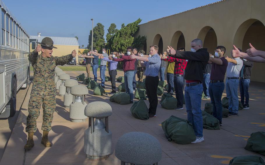 New recruits with Echo Company, 2nd Recruit Training Battalion, respond to orders during receiving at Marine Corps Recruit Depot, San Diego, May 4, 2020. At this point, recruits are informed of the articles under the Uniform Code of Military Justice.