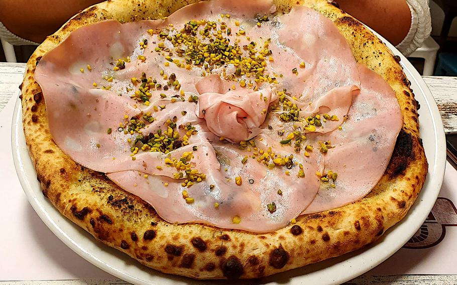 The Bronte pizza from DoDo, Verace Pizza Napoletana in Sacile, Italy, is topped with a pistachio sauce, fresh mozzarella cheese, mortadella ham, grated pistachio, and extra virgin olive oil.