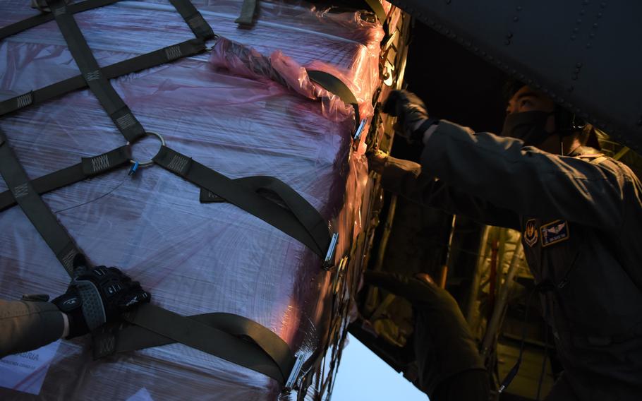 Senior Airman David Tan, 86th Operations Support Squadron aircraft loadmaster, handles pallets of medical equipment in the back of a C-130J Super Hercules during a mission to distribute medical supplies Wednesday, May 13, 2020. The aircraft and flight crew, assigned to Ramstein Air Base, Germany, flew between Milan and Rome in support of pandemic relief efforts.