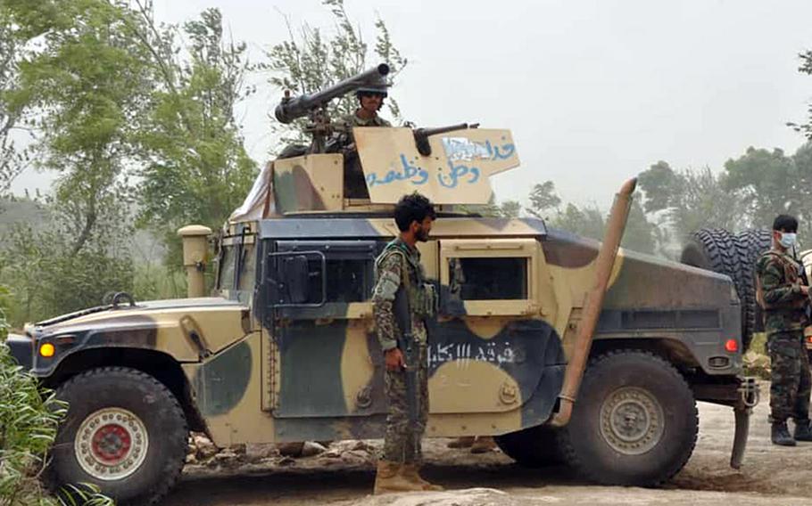 An Afghan soldier stands by a Humvee in northern Kunduz province on Tuesday, May 19, 2020, after the country?s defense ministry said local forces were successful at repelling Taliban advances throughout the night.