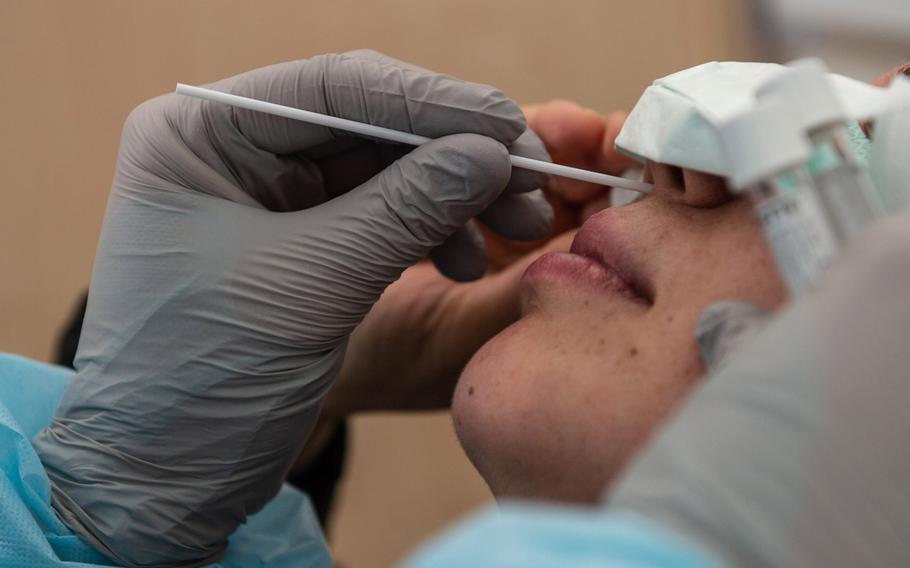 A medical technician uses a nasal swab to test a patient for coronavirus at the COVID-19 clinic at Landstuhl Regional Medical Center, Germany, March 20, 2020. 