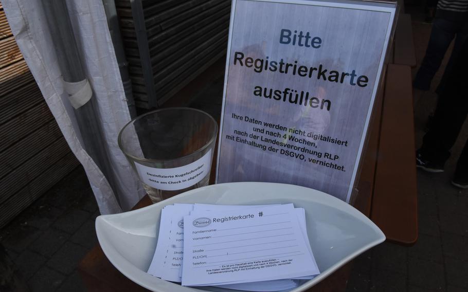 Customers must leave their name and contact information before being seated and served at the Bremerhof beer garden in Kaiserslautern, Germany. The information is for contact tracing, in the event someone else at the restaurant on the same day tests positive for the coronavirus