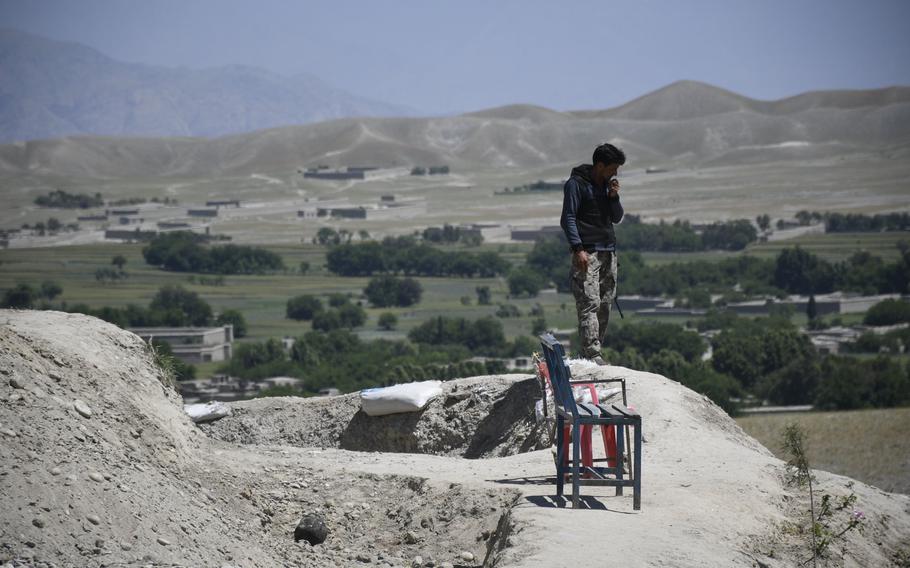 A soldier with the Afghan National Army's Territorial Force looks out from his outpost in rural Nangarhar province of Afghanistan on May 10, 2020. President Ashraf Ghani announced the resumption of offensive operations against the Taliban three days afterward.