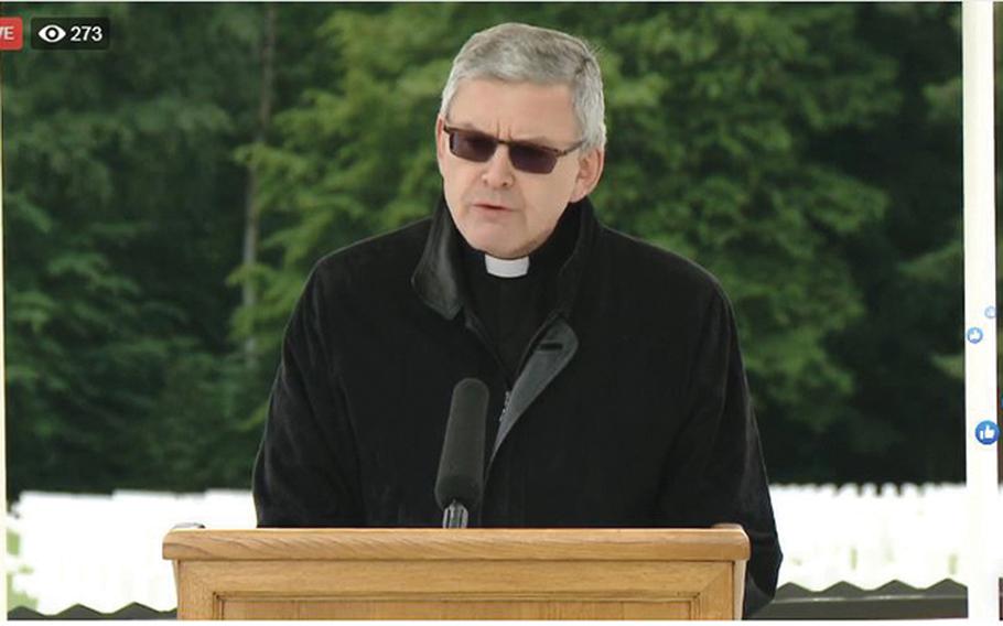 A screenshot shows Father Jean Ehret, a professor of religious studies at Luxembourg's Sacred Heart University, giving the invocation during a Facebook Live stream of the U.S. Embassy in Luxembourg's Memorial Day service at the Luxembourg American Cemetery on Saturday, May 23, 2020.