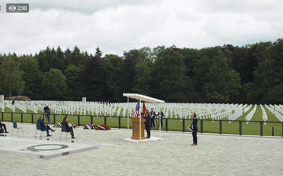 A screenshot of a Facebook Live stream of the U.S. Embassy in Luxembourg's Memorial Day service at the Luxembourg American Cemetery on Saturday, May 23, 2020, shows the few participants at the event seated far apart due to concerns about the coronavirus. Members of the Marine Corps color guard in the background all wore masks.