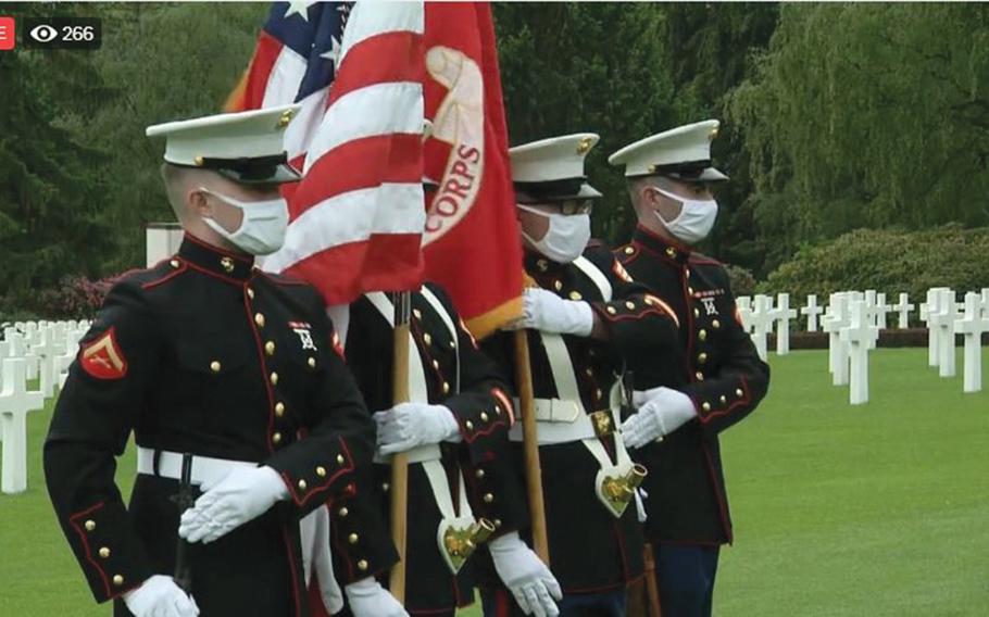Members of a Marine Corps color guard from the U.S. Embassy in Luxembourg wore masks during a Facebook Live stream of the embassy's Memorial Day service at the Luxembourg American Cemetery on Saturday, May 23, 2020, in a screenshot from the event streamed online.
