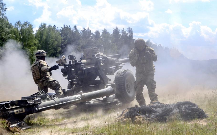 Paratroopers of 4th Battalion, 319th Airborne Field Artillery Regiment, 173rd Airborne Brigade, fire a M119A3 howitzer during a live-fire exercise at Grafenwoehr Training Area, Germany, June 3, 2020. Under the Pentagon's plan to reduce troops in Germany, the unit, now stationed at Grafenwoeh, would move to Vicenza, Italy.