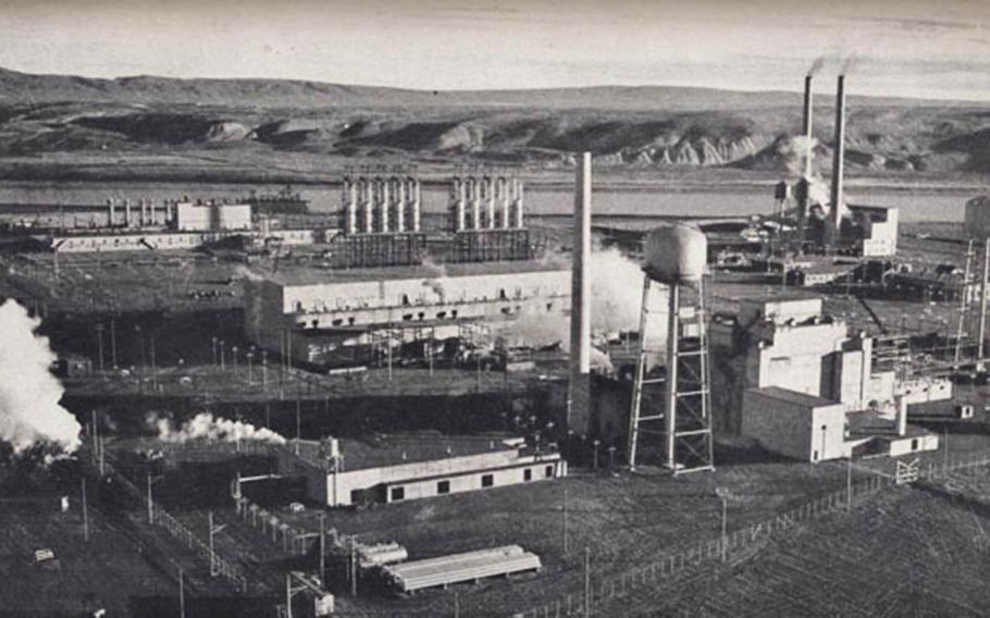 The F Reactor plutonium production complex at Hanford, Wash., is depicted in an undated photograph from the Manhatta Project era. The boxy building between the two water towers on the right is the plutonium production reactor.