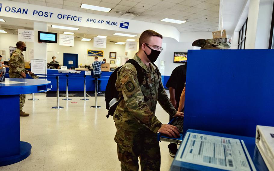 Staff Sgt. Dustin Traylor of the 51st Fighter Wing uses a computer to fill out a customs form inside the post office at Osan Air Base, South Korea, June 16, 2020.