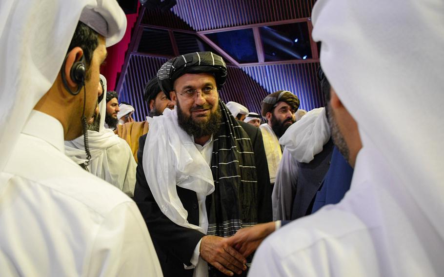 A Taliban official greets others Feb. 29, 2020, in Doha, Qatar, after the group signed a deal with the U.S. that would lead to a withdrawal of foreign forces if the Taliban meets certain conditions. Afghan government officials are expected to depart Thursday for Doha to begin talks with the Taliban.