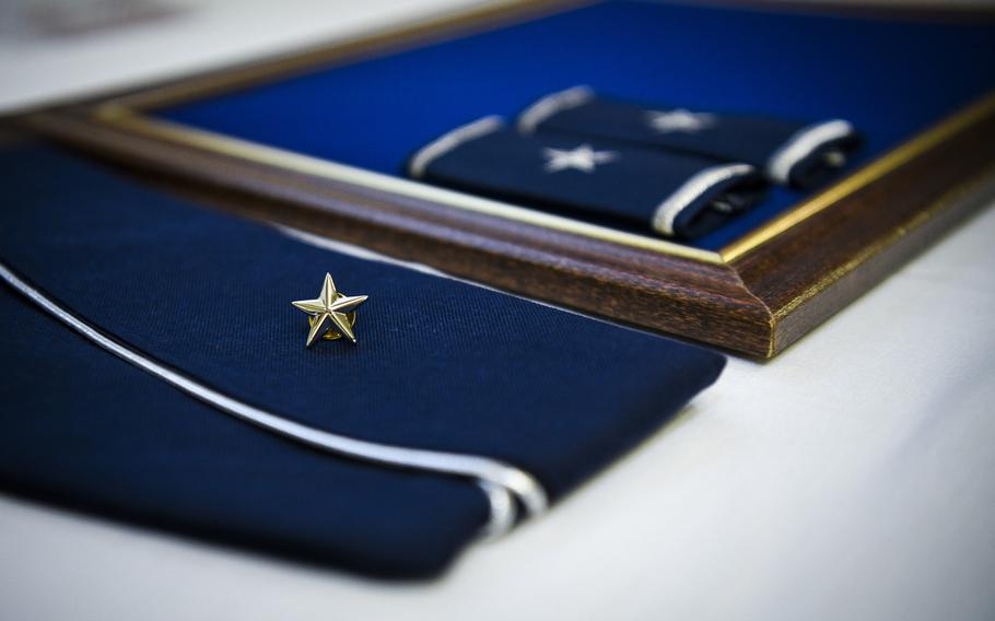 A flight cap with brigadier general rank rests on a desk during a promotion ceremony at Hurlburt Field, Fla., June 8, 2020. A recent Rand Corp. study said the armed services trains and promotes its flag officers in different ways.
