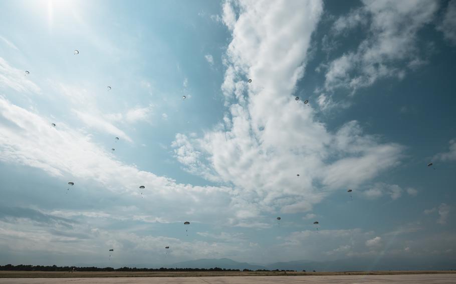 Bulgarian parajumpers head to the ground after jumping from U.S. Air Force C-130J Super Hercules and Bulgarian C-27J Spartan aircraft during the Thracian Summer exercise at Cheshnegirovo landing zone, Bulgaria, Aug. 19, 2020.
