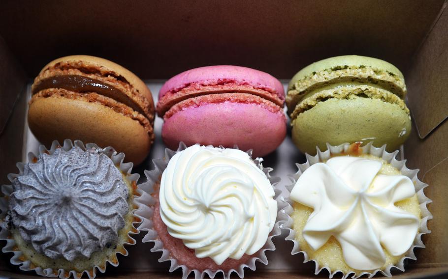 The deserts at PauMi's Sandwiches & more in Wiesbaden, Germany. The top row, from left, are caramel, strawberry and pistachio macarons. The mini-cupcakes on the bottom from left are chocolate with chocolate buttercream, strawberry with lemon buttercream and vanilla with vanilla buttercream.