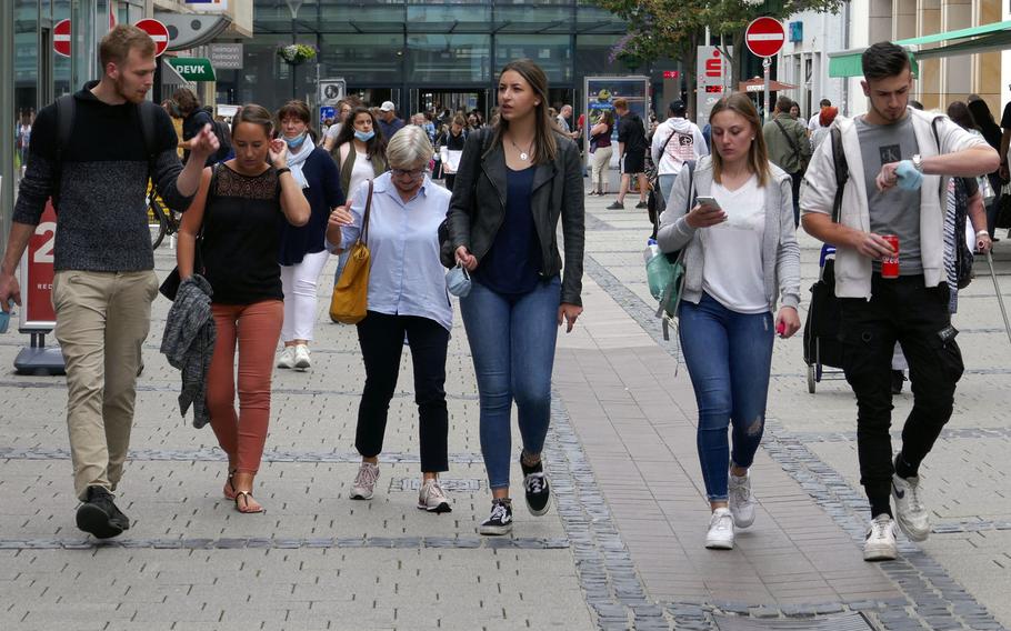 People walk down Fackelstrasse in downtown Kaiserslautern, Germany, Aug. 25, 2020. The number of active coronavirus cases more than doubled in the Kaiserslautern area, which is home to tens of thousands of U.S. troops and their families, in the past week, and is up sharply around Germany, officials said.