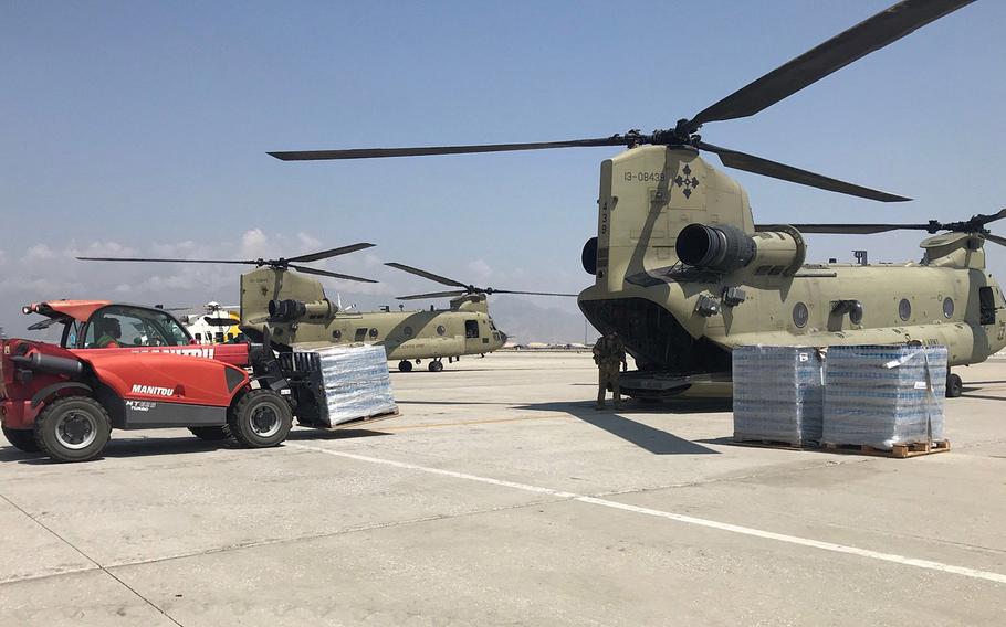 A U.S. Army C-47 Chinook helicopter is loaded with pallets of supplies, as the U.S.-led NATO mission in Afghanistan teamed up with local forces to deliver supplies to civilians affected by recent floods.