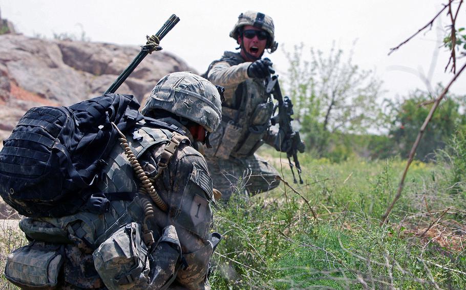 Staff Sgt. Dylan Lugibihl, 24, of Napoleon, Ohio, with Company A, 2nd Battalion, 2nd Infantry Regiment, shouts orders during a firefight with Taliban insurgents near the village of Zangabad  in Kanadahar province, Afghanistan, in April 2009. Veterans of the war are divided about the looming U.S. withdrawal from Afghanistan, with some bitter that the pull-out was born out of a deal with the enemy they fought, while others say it's time to end American involvement in a wasteful war.