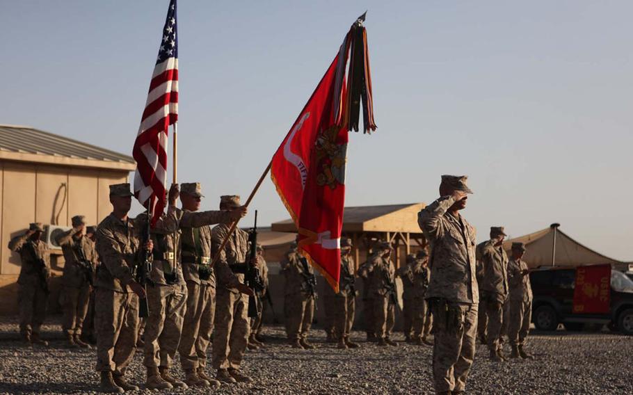 U.S. Marines with Regimental Combat Team 5 color guard present the colors during the 10th anniversary ceremony of 9/11 at Camp Dwyer, Afghanistan, on Sept. 11, 2011. Veterans of the war are divided about the U.S. withdrawal from Afghanistan, with some bitter that the pull-out was born out of a deal with the enemy they fought, while others say it's time to end American involvement in the war.