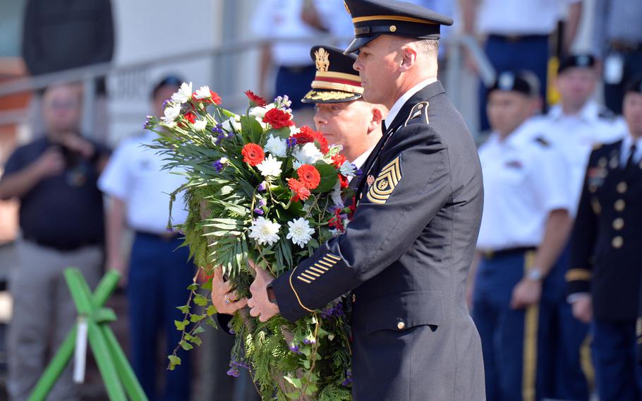 Col. Douglas Levien, 21st Theater Sustainment Command deputy commander, left, and Command Sgt. Maj. Sean Howard place a wreath during 9/11 remembrance ceremony hosted by the 21st TSC in Kaiserslautern, Germany, Sept. 11, 2020.