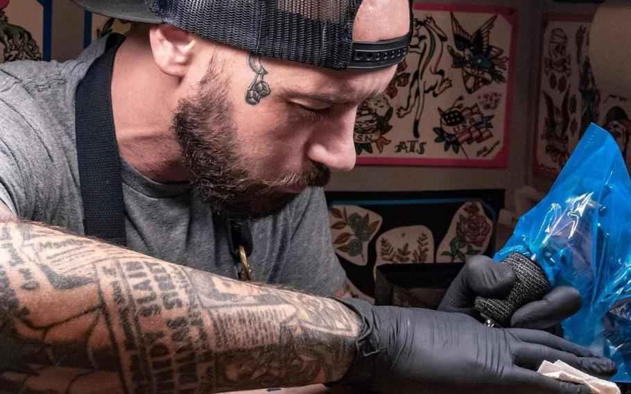 Mathias Moretti creates a tattoo for the first time at a shop on a U.S. military installation at American Tattoo Society on Nellis Air Force Base, Nev., Sept. 4, 2020.