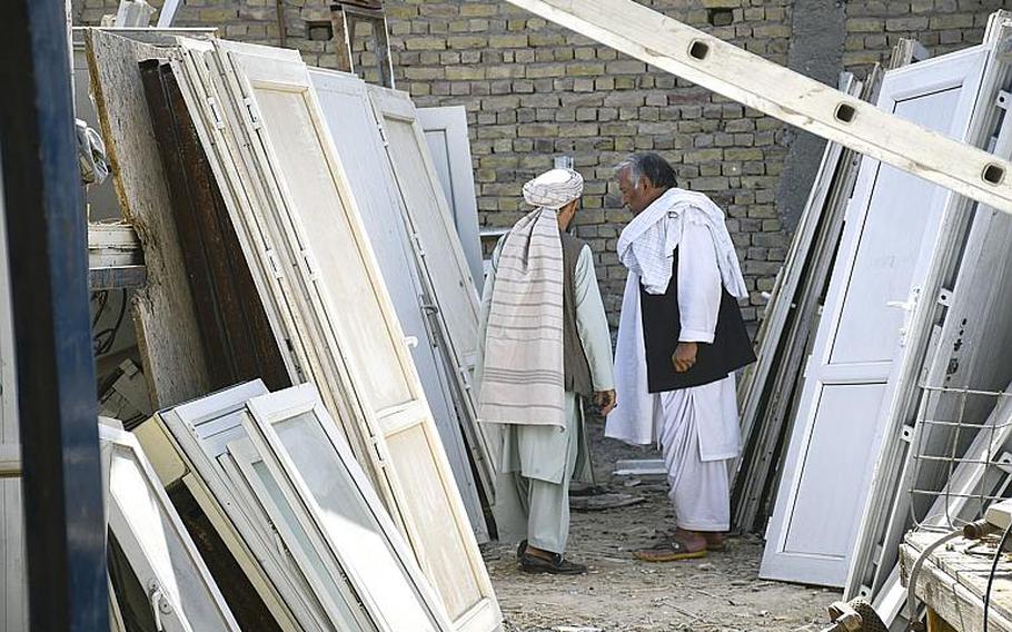 Locals in Kandahar, Afghanistan, shop Saturday, Oct. 31, 2020, at ''Bush Bazaar,'' where doors are among the items thrown out by U.S. and NATO troops and contractors that are available for purchase.