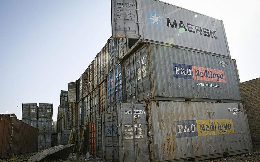 Shipping containers pile high at a bazaar in southern Afghanistan where goods that once belonged to U.S. and NATO troops and contractors at Kandahar Airfield are sold to locals. Empty containers sell for about $800 and can be used as shops or offices, a local vendor said.