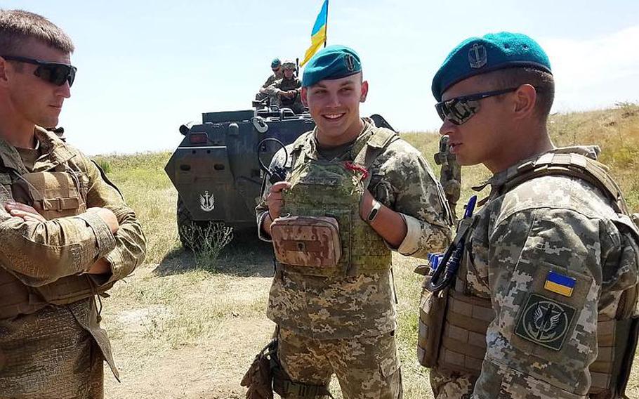 Ukrainian marine Cpt. Alexander Tonenchuk, right, the executive officer of 1st Marine Battalion, speaks to his Marines during training with American Marines at Exercise Sea Breeze, Saturday, July 14, 2018. 