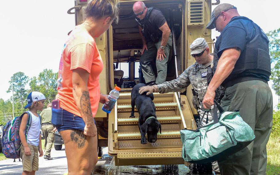 U.S. Air Force Security Forces Airmen assigned to the South Carolina Air National Guard, 169th Fighter Wing, assist the Florence County, S.C., Sheriff's Department with evacuation efforts in Florence, S.C., Sept. 17, 2018.