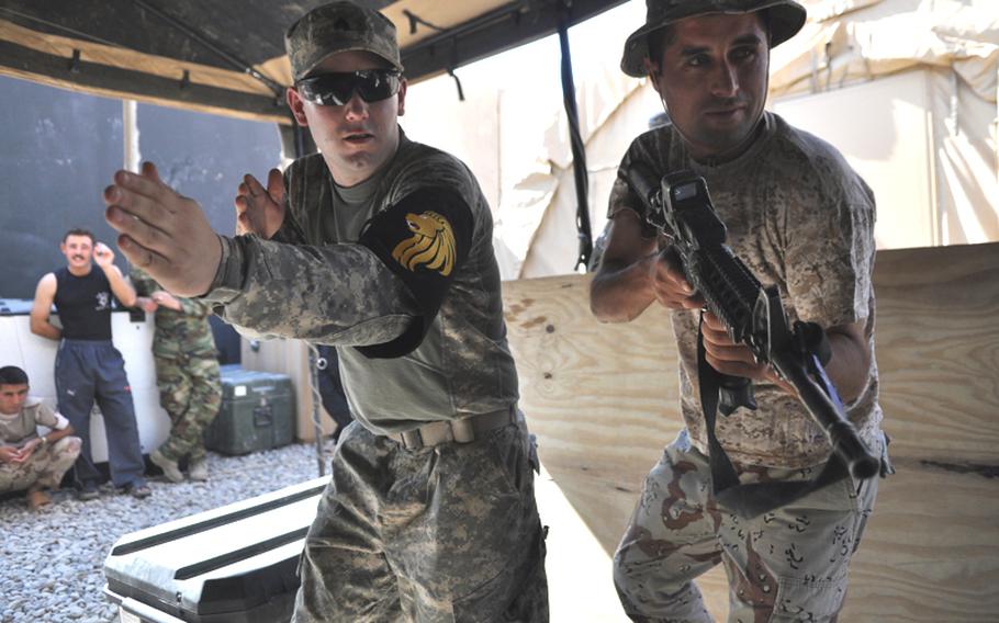 Sgt. Ryan Carlson, left, shows an Iraqi soldier how to raid a home at Checkpoint 3, a small base outside Mosul. Training the Iraqi security forces will be key as the U.S. nears the 2011 deadline to withdraw all troops.