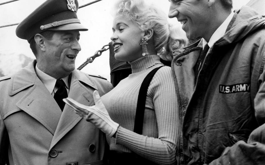 Bodybuilder Mickey Hargitay, right, and his soon-to-be wife, actress Jayne Mansfield, talk with U.S. Army Capt. Ernest Babin, chief of recreation at Eighth Army Special Services, during one Bob Hope's holiday tour stops in Korea.