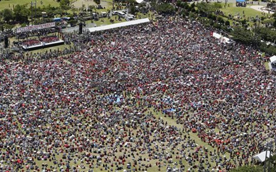 People gather Sept. 9, 2012, for a rally against a planned U.S. deployment of Osprey aircraft in Ginowan, on the southern island of Okinawa, Japan. Thousands of people gathered to demand that a plan to deploy 12 MV-22 Osprey aircraft on the island be scrapped, saying they are unsafe. The U.S. plans to deploy them to replace older CH-46 helicopters.