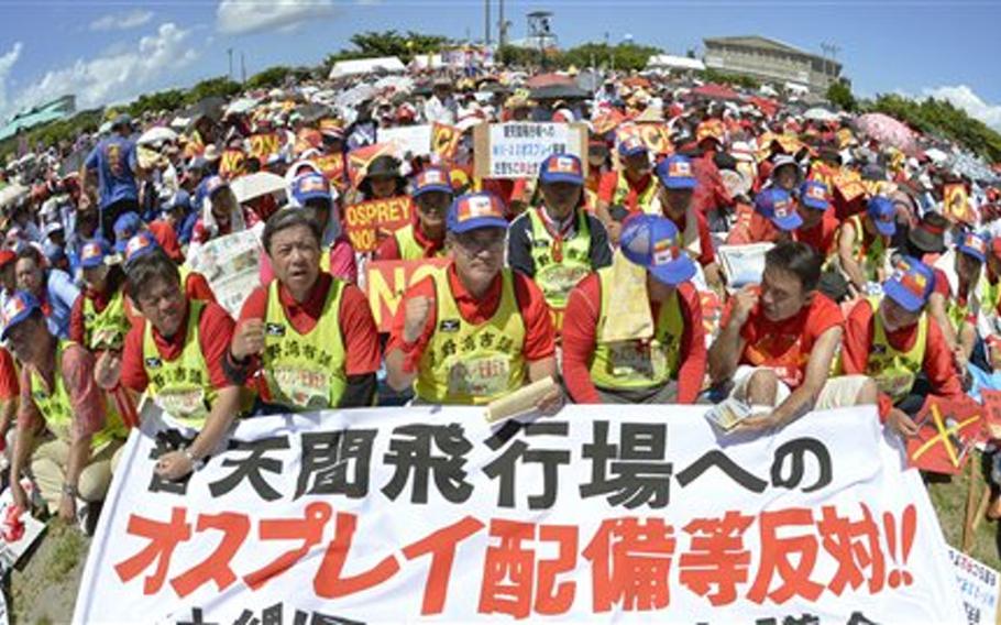 Protesters hold a banner reading "Oppose a deployment of Osprey to Futenma Airfield" during a rally Sept. 9, 2012, held at a seaside park in Ginowan, Okinawa Prefecture, Japan. Protesters oppose a U.S. plan to deploy 12 MV-22 Osprey aircraft on the island.