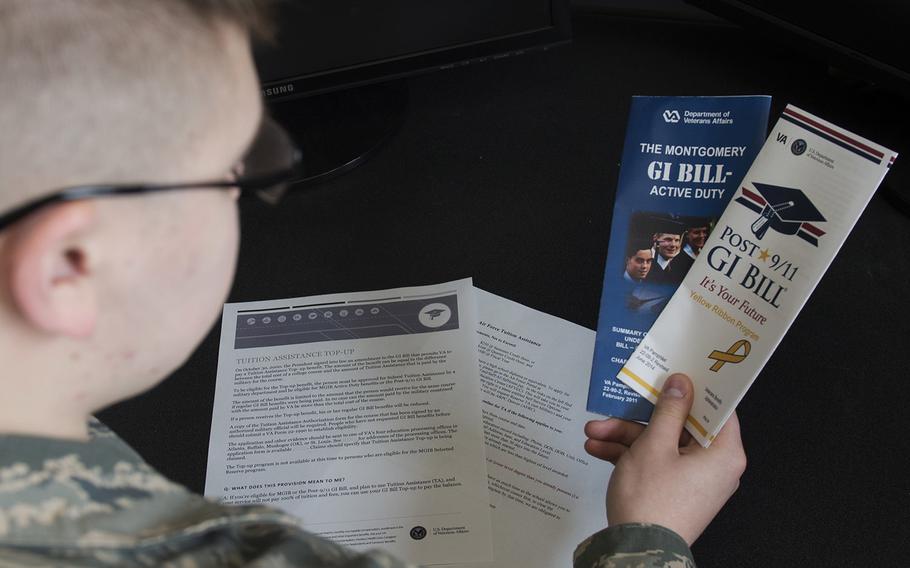 Airman Dalton Shank, 5th Bomb Wing public affairs specialist, reads pamphlets on the Montgomery GI Bill and the Post-9/11 GI Bill.