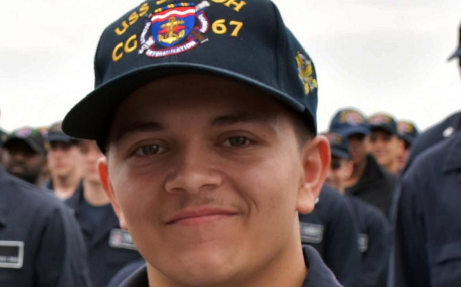 Peter Mims poses for a photo after being frocked to the rank of petty officer third class during a ceremony aboard the USS Shiloh May 25.