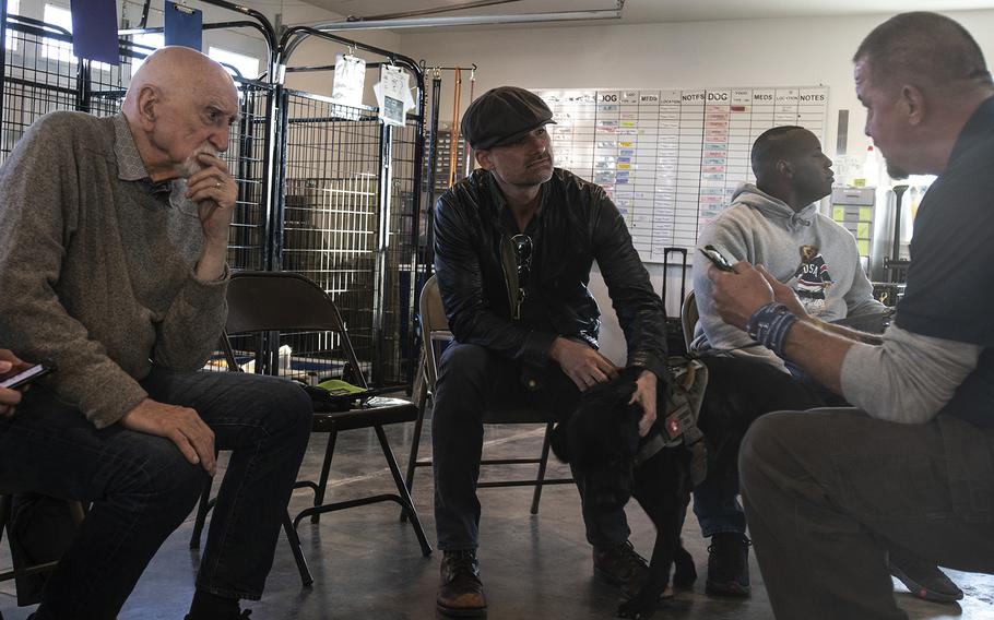 Actors Dominic Chianese (left) and Warren Christie (center), cast of the new TV show "The Village," visit Warrior Canine Connection in Boyds, Maryland, on November 10, 2018, to learn about service dogs and their role helping veterans. The show will air in 2019. (Meredith Tibbetts/Stars and Stripes)