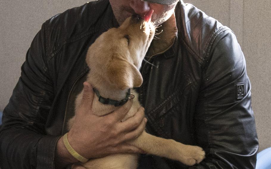 Warren Christie, part of the cast of the new TV show "The Village" visit Warrior Canine Connection in Boyds, Maryland, on November 10, 2018, to learn about service dogs and their role helping veterans. The show will air in 2019.