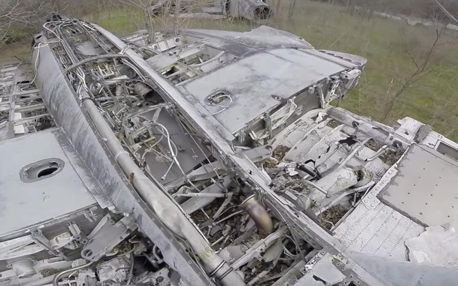 The remains of two Navy F-14 Tomcats and an F-4 Phantom II sit in an overgrown field in Temple, Texas. 