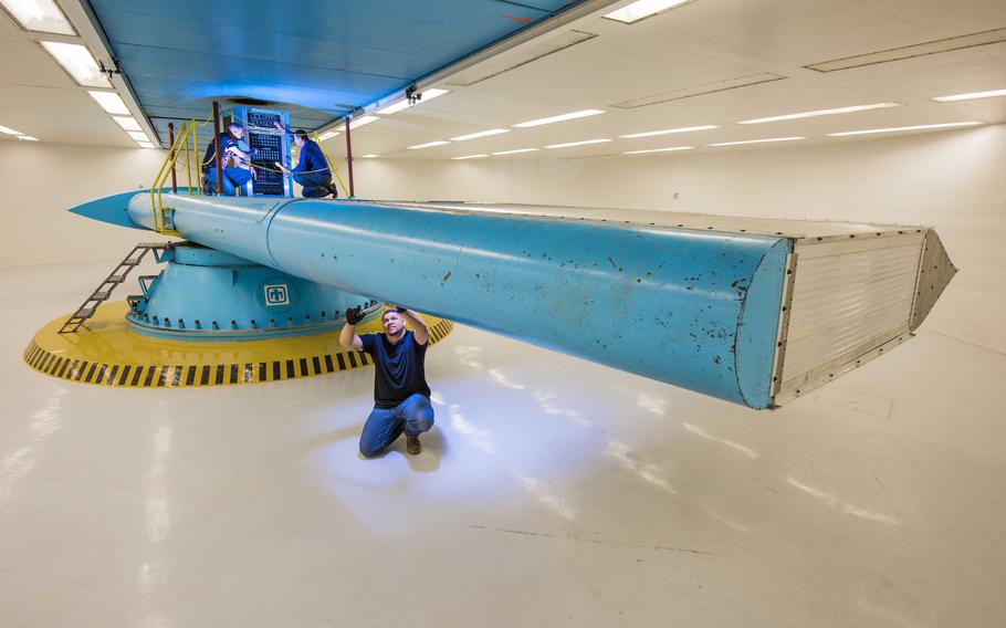 A Sandia National Laboratories employee performs maintenance on a centrifuge in this undated file photo.